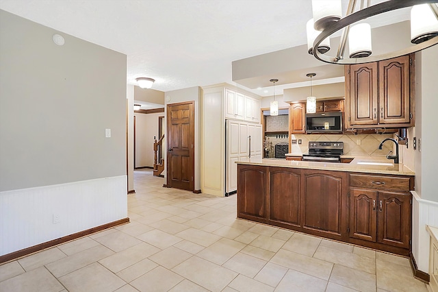 kitchen featuring tasteful backsplash, sink, hanging light fixtures, kitchen peninsula, and electric stove