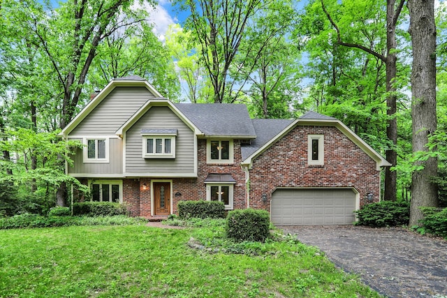 view of property featuring a garage and a front yard