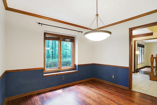 empty room with crown molding and dark hardwood / wood-style flooring