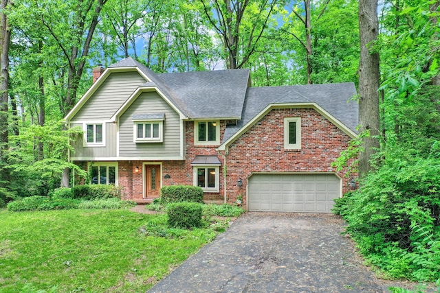 view of front of property featuring a garage and a front lawn