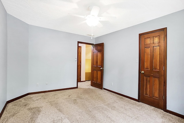 unfurnished bedroom featuring ceiling fan and light colored carpet