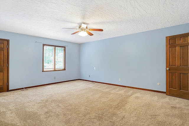 unfurnished room featuring ceiling fan, carpet, and a textured ceiling