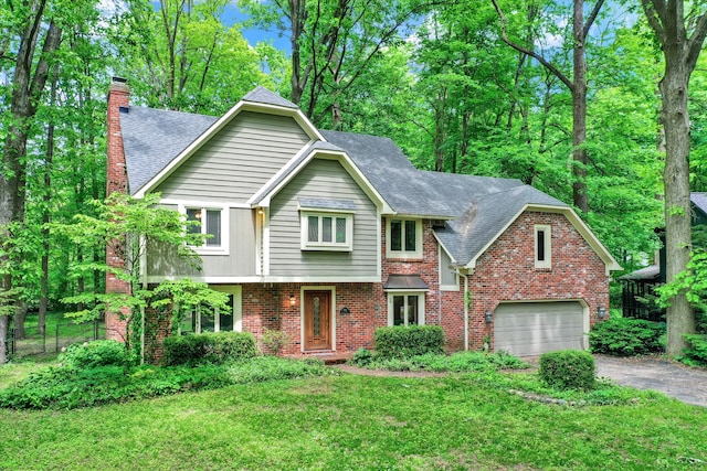 view of front property featuring a garage and a front yard