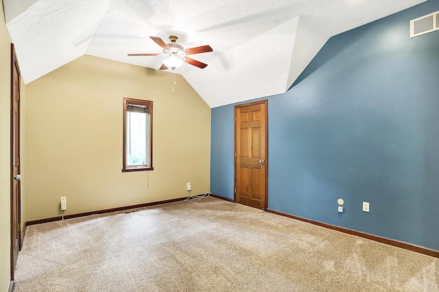 additional living space featuring ceiling fan, lofted ceiling, carpet flooring, and a textured ceiling