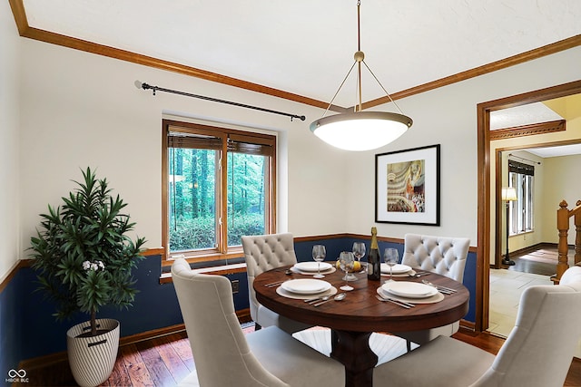 dining space featuring crown molding and dark hardwood / wood-style floors