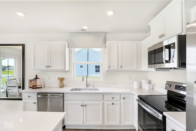 kitchen with white cabinetry, sink, and stainless steel appliances