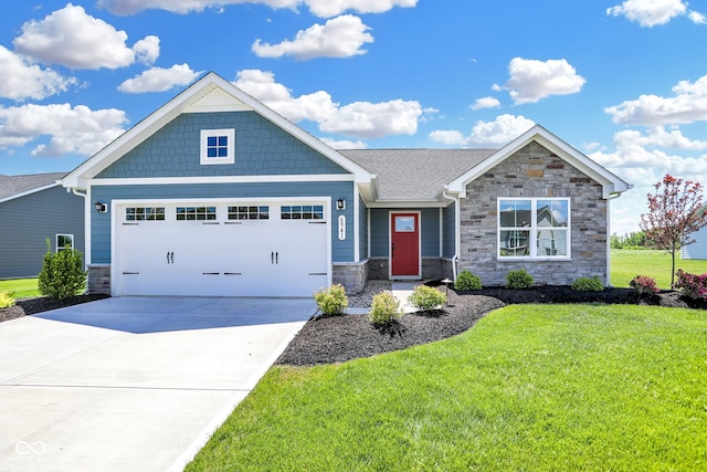 craftsman inspired home featuring a front yard and a garage