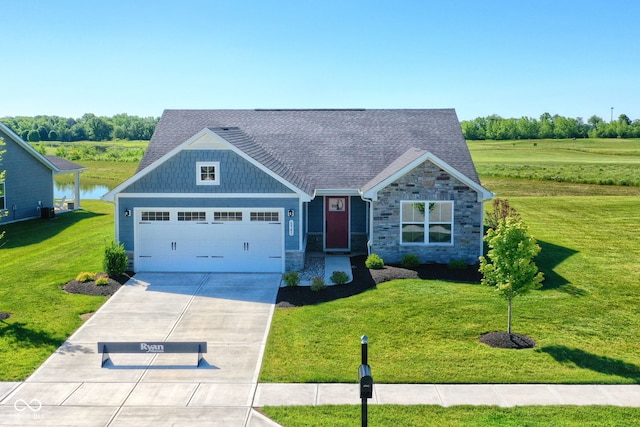 craftsman-style house featuring a water view, a front lawn, and a garage