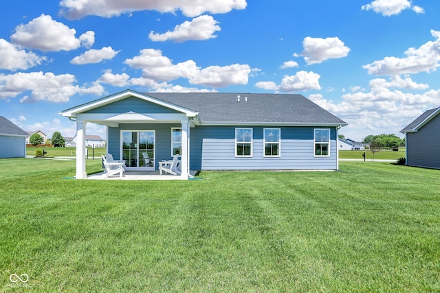 rear view of house featuring a patio area and a yard