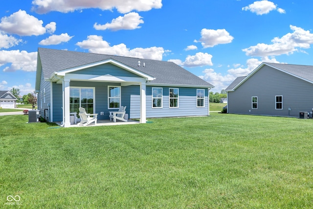 back of house with a lawn, cooling unit, and a patio