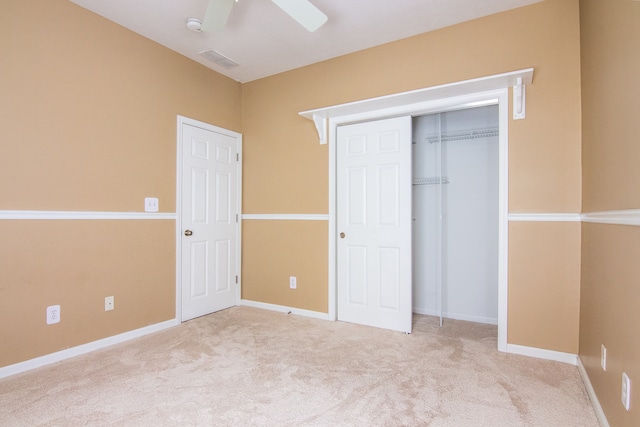 unfurnished bedroom featuring ceiling fan and carpet floors