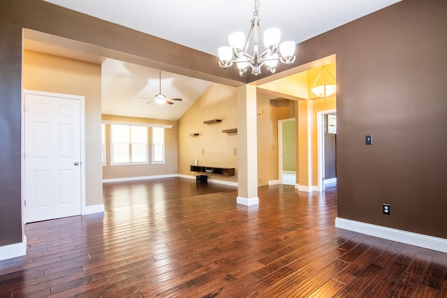 interior space featuring ceiling fan with notable chandelier, vaulted ceiling, and dark hardwood / wood-style flooring