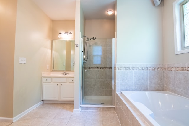 bathroom with shower with separate bathtub, vanity with extensive cabinet space, and tile floors