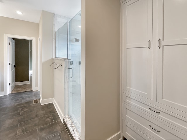 bathroom featuring walk in shower and tile floors