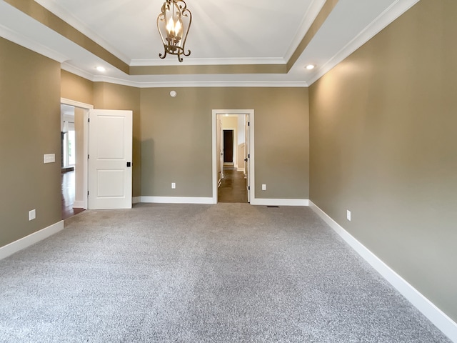 interior space featuring a chandelier, a raised ceiling, and crown molding