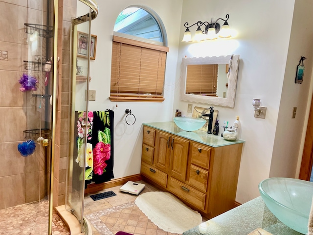 bathroom featuring tile patterned floors, vanity, and walk in shower