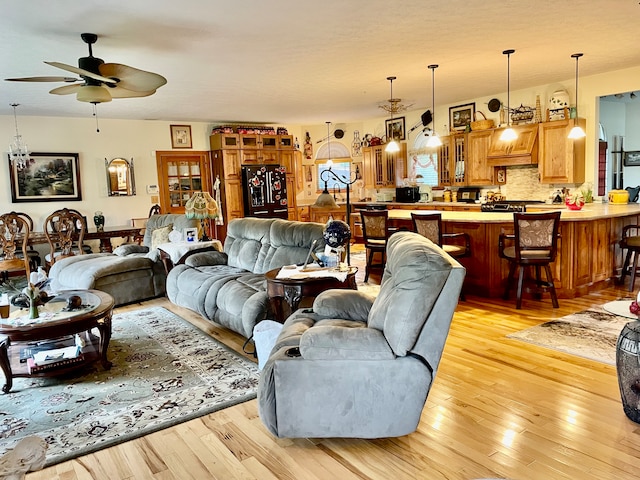 living room featuring light hardwood / wood-style flooring and ceiling fan