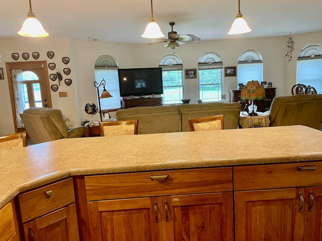 kitchen with decorative light fixtures, plenty of natural light, and ceiling fan