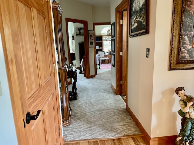 corridor with light colored carpet