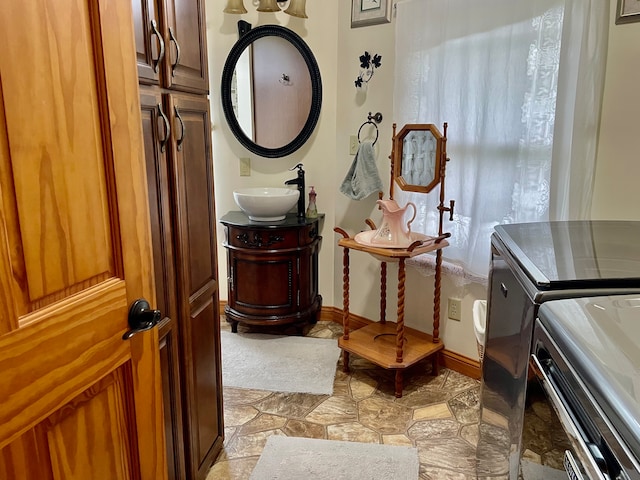 washroom featuring cabinets, separate washer and dryer, and sink