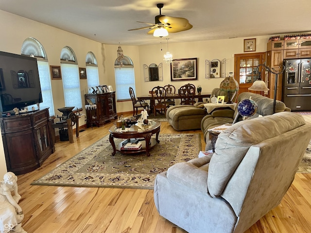 living room featuring ceiling fan and light wood-type flooring