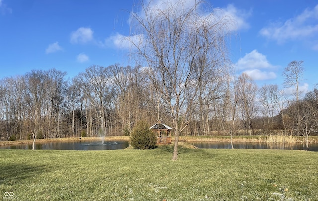 view of yard featuring a gazebo and a water view