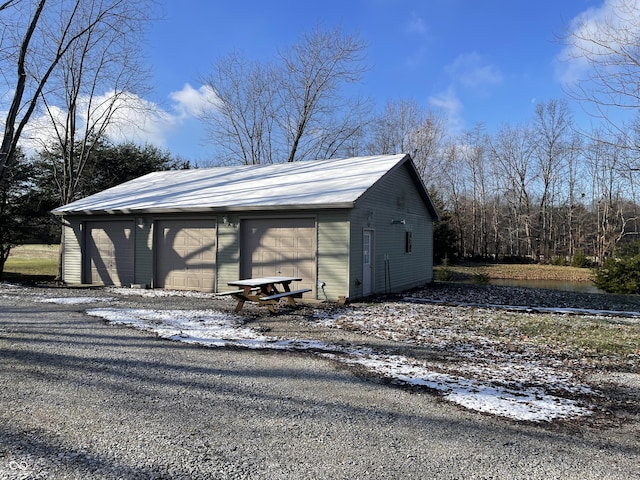 snow covered structure with a garage