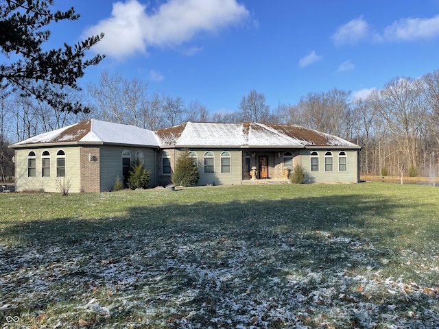 rear view of house featuring a yard