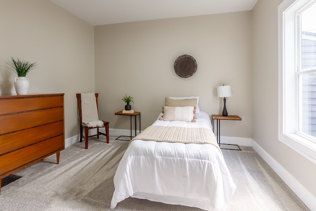 carpeted bedroom featuring multiple windows