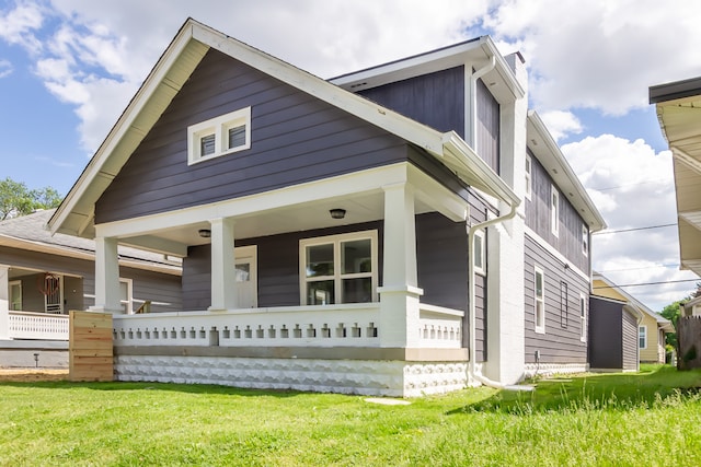 view of front of house featuring a front yard and covered porch