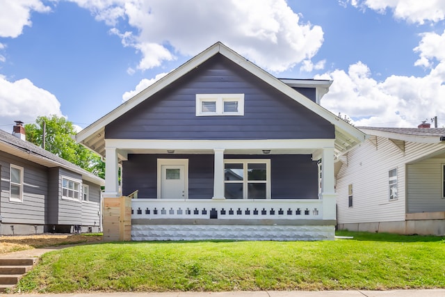 bungalow with a front yard and a porch