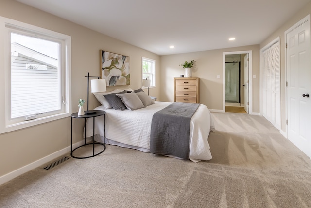 carpeted bedroom featuring ensuite bathroom