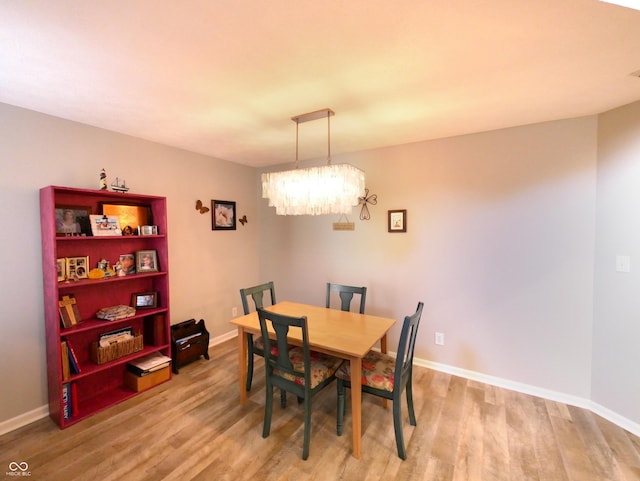 dining room with an inviting chandelier and light hardwood / wood-style floors