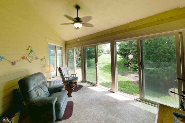 sunroom / solarium with a healthy amount of sunlight, ceiling fan, and vaulted ceiling