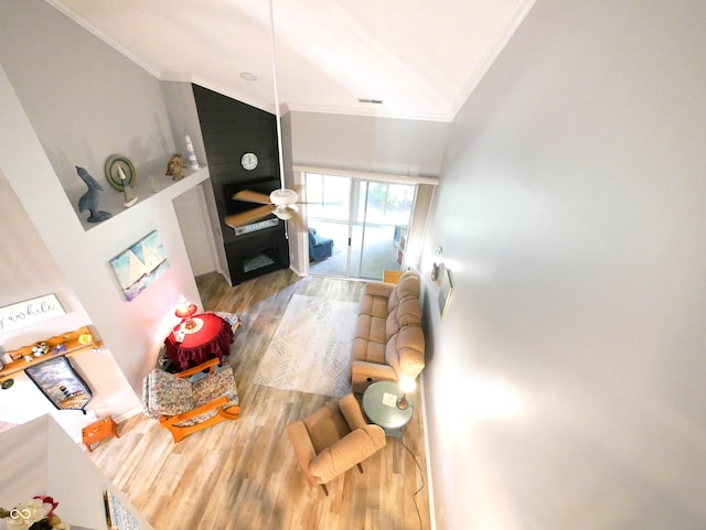 living room featuring high vaulted ceiling, wood-type flooring, and crown molding