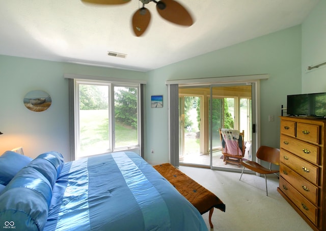 bedroom featuring access to outside, multiple windows, ceiling fan, and vaulted ceiling