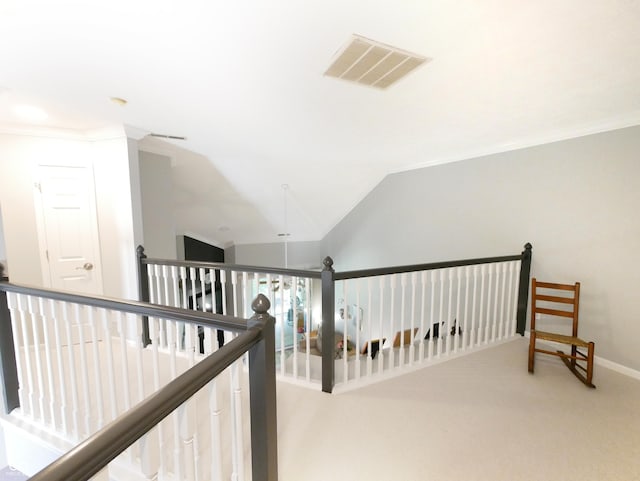 corridor featuring vaulted ceiling, carpet flooring, and ornamental molding