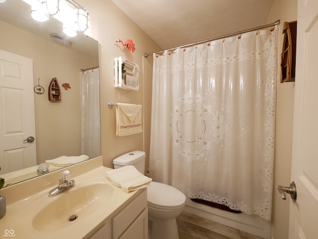 bathroom with wood-type flooring, a textured ceiling, toilet, and vanity