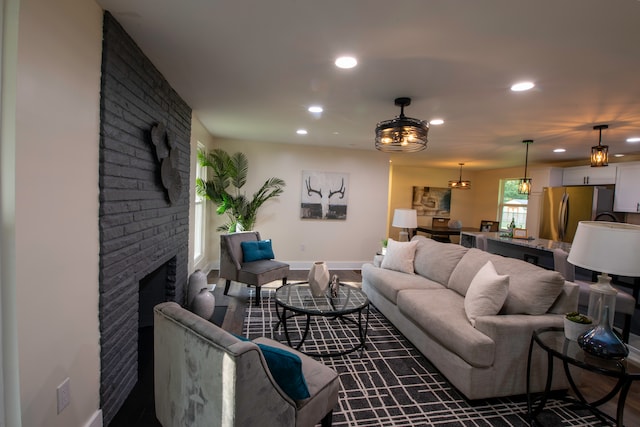 living room with brick wall and a brick fireplace