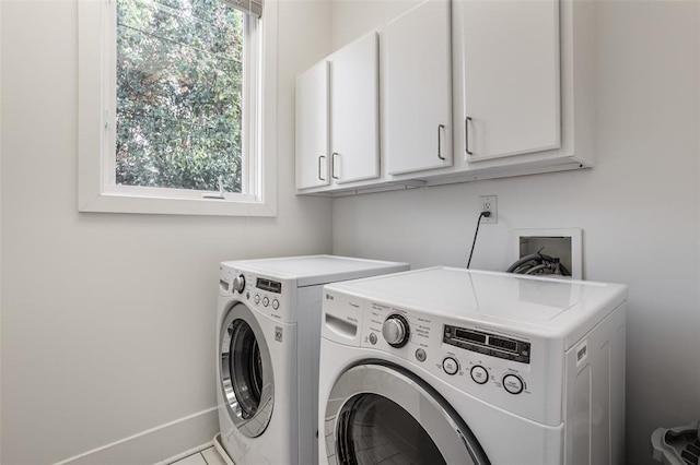 laundry area with a healthy amount of sunlight, washer and dryer, cabinets, and hookup for a washing machine