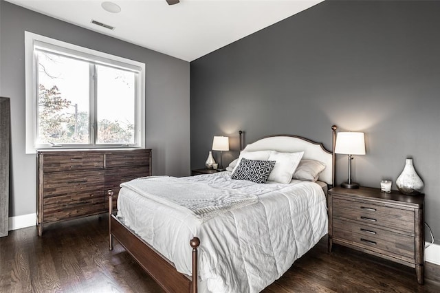 bedroom with dark hardwood / wood-style flooring