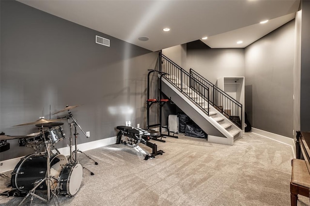 exercise room with light colored carpet