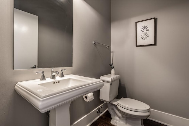 bathroom featuring sink, hardwood / wood-style floors, and toilet