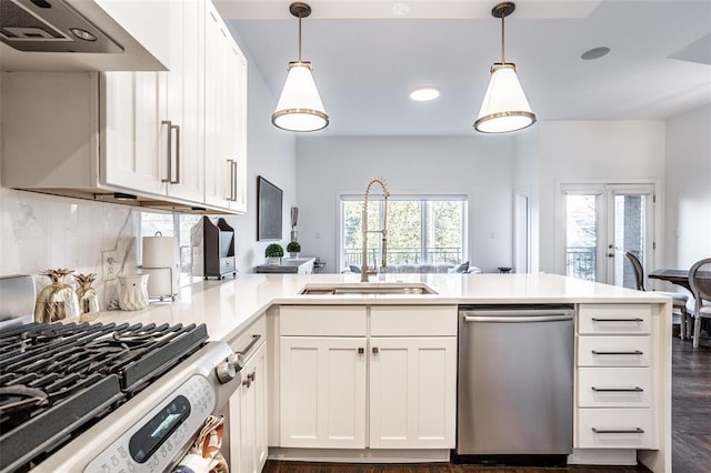 kitchen with gas range oven, kitchen peninsula, dishwasher, custom exhaust hood, and dark wood-type flooring