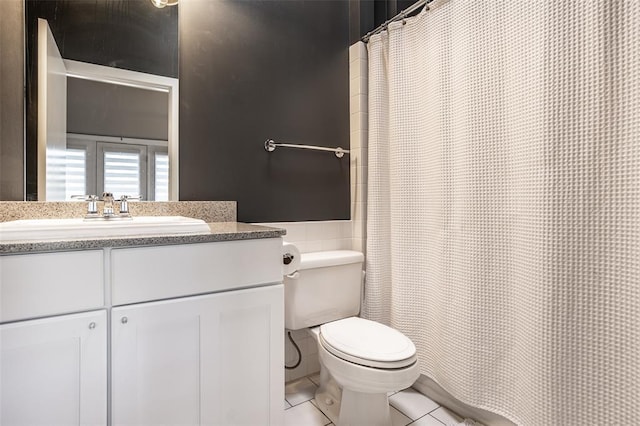 bathroom with tile flooring, vanity, and toilet