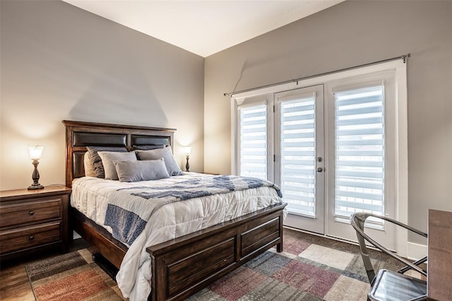 bedroom featuring dark wood-type flooring, french doors, and access to outside