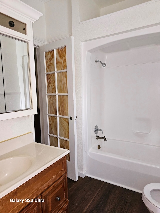 full bathroom featuring wood-type flooring, vanity, toilet, and shower / bathtub combination