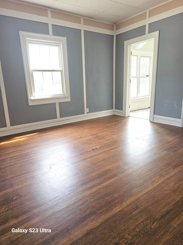 unfurnished room featuring plenty of natural light and hardwood / wood-style flooring