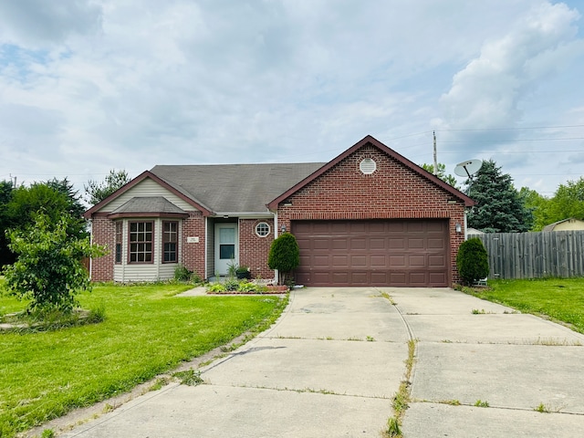 single story home with a garage and a front lawn