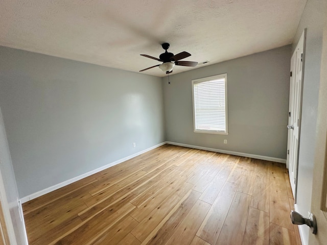 empty room featuring a textured ceiling, ceiling fan, and light hardwood / wood-style flooring